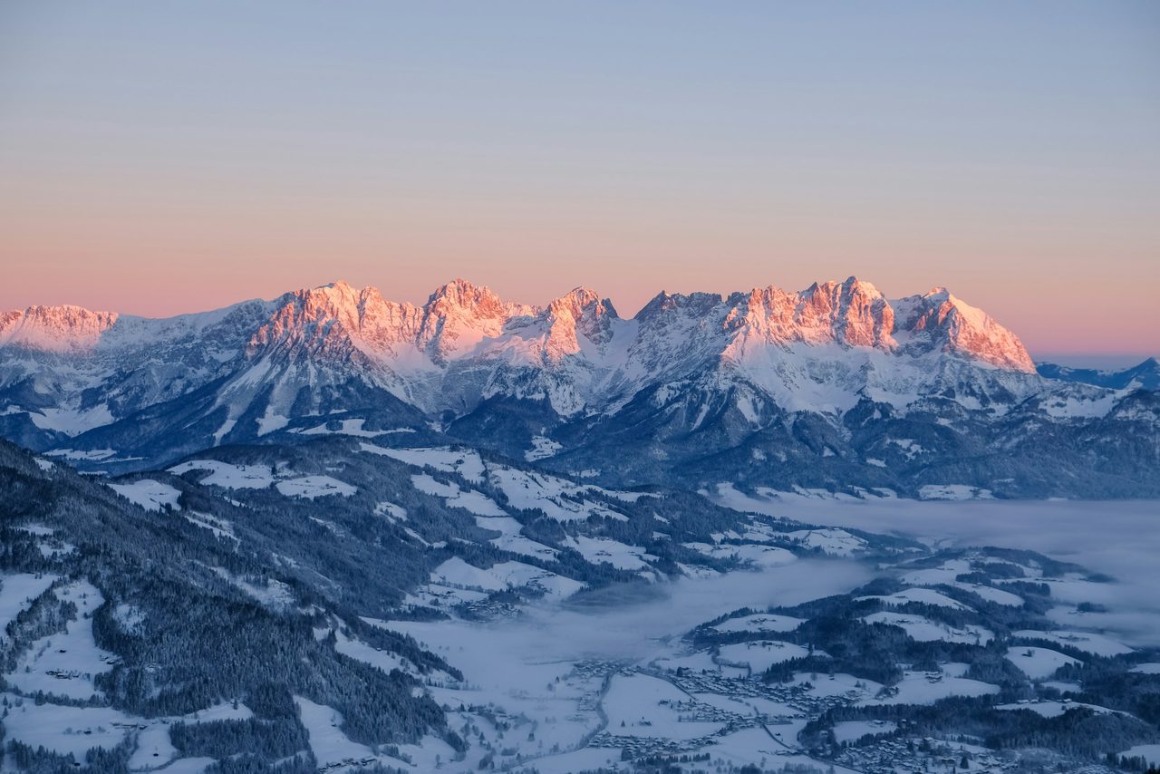 Verschneite Bergkette im Abendrot bei Kitzbühel